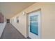 Exterior hallway entrance door featuring glass panel, the number 203, and a view of the complex through the glass at 1250 N Portofino Dr # 203, Sarasota, FL 34242