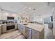 Beautiful open kitchen with granite countertops, stainless appliances, views of the living room, and access to balcony at 1250 N Portofino Dr # 203, Sarasota, FL 34242
