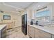 Kitchen featuring modern stainless appliances, granite countertops, custom cabinets, and mosaic backsplash at 1250 N Portofino Dr # 203, Sarasota, FL 34242