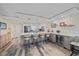 Open kitchen featuring an oversized island with pendant lighting, stainless appliances, and built-in wine storage at 1250 N Portofino Dr # 203, Sarasota, FL 34242