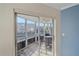 Enclosed lanai with seating area offers views of the canal and nearby buildings at 1250 N Portofino Dr # 203, Sarasota, FL 34242