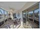 Inviting lanai with seating area, ceiling fan, and views of the water at 1250 N Portofino Dr # 203, Sarasota, FL 34242