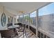 Spacious lanai includes a dining table and seating area overlooking the canal at 1250 N Portofino Dr # 203, Sarasota, FL 34242