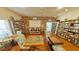 Cozy community library with bookshelves, tables, chairs, and a reading area at 1250 N Portofino Dr # 203, Sarasota, FL 34242