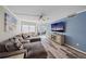Cozy living room with large sectional, accent wall, and sliding glass doors to lanai at 1250 N Portofino Dr # 203, Sarasota, FL 34242