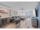 Bright living room features a large sectional, wood-look tile floors, and a wet bar at 1250 N Portofino Dr # 203, Sarasota, FL 34242