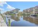 Scenic waterfront view of the condos from the canal, with boats docked nearby at 1250 N Portofino Dr # 203, Sarasota, FL 34242