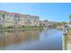 Beautiful waterfront view of the condo building from the canal, with docks and boats at 1250 N Portofino Dr # 203, Sarasota, FL 34242