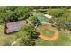 Community aerial view showcasing the baseball field, tennis court, and basketball courts near the pond at 12723 Rockrose Gln, Lakewood Ranch, FL 34202