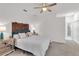 Cozy bedroom featuring a decorative headboard and ensuite bathroom access at 12723 Rockrose Gln, Lakewood Ranch, FL 34202