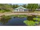 Community clubhouse overlooking the pond with lily pads, providing a scenic view at 12723 Rockrose Gln, Lakewood Ranch, FL 34202