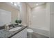 Bright bathroom featuring granite countertop vanity, large mirror, and shower over tub at 13804 Camden Crest Ter, Lakewood Ranch, FL 34211