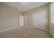 Bedroom with neutral carpet, closet with double doors, and neutral colored walls at 13804 Camden Crest Ter, Lakewood Ranch, FL 34211