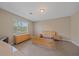 Neutral-toned bedroom with empty bed frame, tile floors, and dresser at 13804 Camden Crest Ter, Lakewood Ranch, FL 34211