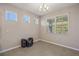 Bright, window-filled room with tile flooring, neutral walls, and modern chandelier at 13804 Camden Crest Ter, Lakewood Ranch, FL 34211