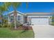 Charming single-story home featuring a manicured lawn, stone accents, and a two-car garage at 13804 Camden Crest Ter, Lakewood Ranch, FL 34211