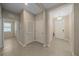 Neutral-toned hallway with multiple doors and tile flooring at 13804 Camden Crest Ter, Lakewood Ranch, FL 34211