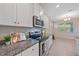 Detailed kitchen with granite counters, stainless appliances, white cabinets and eat in nook at 13804 Camden Crest Ter, Lakewood Ranch, FL 34211