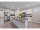 Open kitchen with a large island, stainless steel appliances, granite countertops, and ample storage space at 13804 Camden Crest Ter, Lakewood Ranch, FL 34211