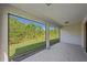A spacious screened-in lanai showcases the lush green backyard and surrounding landscape at 13804 Camden Crest Ter, Lakewood Ranch, FL 34211