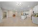 Spacious living room and kitchen area with tile flooring and a kitchen island at 13804 Camden Crest Ter, Lakewood Ranch, FL 34211