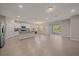 Open-concept living room and kitchen featuring tile floors and ample natural light at 13804 Camden Crest Ter, Lakewood Ranch, FL 34211