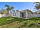 Beautiful backyard featuring a well-maintained lawn, a palm tree, and a covered patio at 1422 19Th St, Sarasota, FL 34234