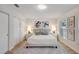 Comfortable bedroom with light wood floors, slider closet doors, and modern decorations at 1422 19Th St, Sarasota, FL 34234