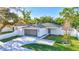 Charming single-story home with a well-manicured front lawn, two car garage, and beautiful landscaping at 1422 19Th St, Sarasota, FL 34234