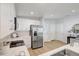 Close-up of the kitchen with stainless steel appliances and sleek white cabinetry at 1422 19Th St, Sarasota, FL 34234