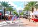 Lively downtown street scene with palm trees, shops, people, and food vendors in open area at 1422 19Th St, Sarasota, FL 34234