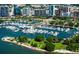 Aerial view of a marina with numerous boats docked in the clear blue water, surrounded by lush green landscapes at 1426 19Th St, Sarasota, FL 34234