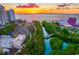 Aerial shot capturing a colorful sunset over the bay, city buildings, and a vibrant park with a live concert at 1426 19Th St, Sarasota, FL 34234