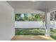 Covered back porch overlooks the grassy fenced-in backyard at 1426 19Th St, Sarasota, FL 34234