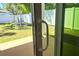 Backyard access through sliding glass door with a serene view of the fenced yard at 1426 19Th St, Sarasota, FL 34234