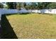 A large backyard with a white privacy fence ensures plenty of space for outdoor activities and relaxation at 1426 19Th St, Sarasota, FL 34234