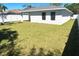 A spacious backyard featuring lush grass and bordered by a white privacy fence, offering a private outdoor area at 1426 19Th St, Sarasota, FL 34234