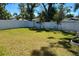 A large backyard with a white privacy fence ensures plenty of space for outdoor activities and relaxation at 1426 19Th St, Sarasota, FL 34234