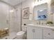 Stylish bathroom with glass-enclosed shower, white vanity, modern fixtures, and decorative accents at 1426 19Th St, Sarasota, FL 34234