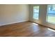 Neutral bedroom featuring wood-look flooring and bright natural light from two windows at 1426 19Th St, Sarasota, FL 34234