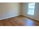 Neutral bedroom featuring wood-look flooring and natural light from a single window at 1426 19Th St, Sarasota, FL 34234