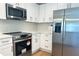 Bright kitchen featuring modern appliances and sleek white cabinetry at 1426 19Th St, Sarasota, FL 34234