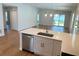 Open-concept kitchen with stainless steel dishwasher overlooks the living area at 1426 19Th St, Sarasota, FL 34234