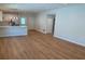 Open-concept living space with wood-look flooring, bright natural light, and a modern kitchen at 1426 19Th St, Sarasota, FL 34234