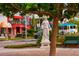 Scenic street view with a statue, tree, vibrant buildings, and a colorful trolley in the background at 1426 19Th St, Sarasota, FL 34234