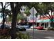 A charming street view with a variety of shops, cars parked along the road, and lush trees at 1426 19Th St, Sarasota, FL 34234