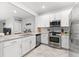 Well-lit kitchen with white cabinetry, stainless steel appliances, and a breakfast bar at 15225 Lyla Ter, Bradenton, FL 34211