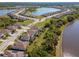 A lovely aerial view showcasing homes nestled along a scenic lake with tree lined properties at 18013 Polo Trl, Bradenton, FL 34211