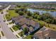 Aerial view showing the property's location within a beautifully planned community near a lake at 18013 Polo Trl, Bradenton, FL 34211