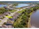 An aerial view of homes with lake views and lush greenery in a well-maintained neighborhood at 18013 Polo Trl, Bradenton, FL 34211